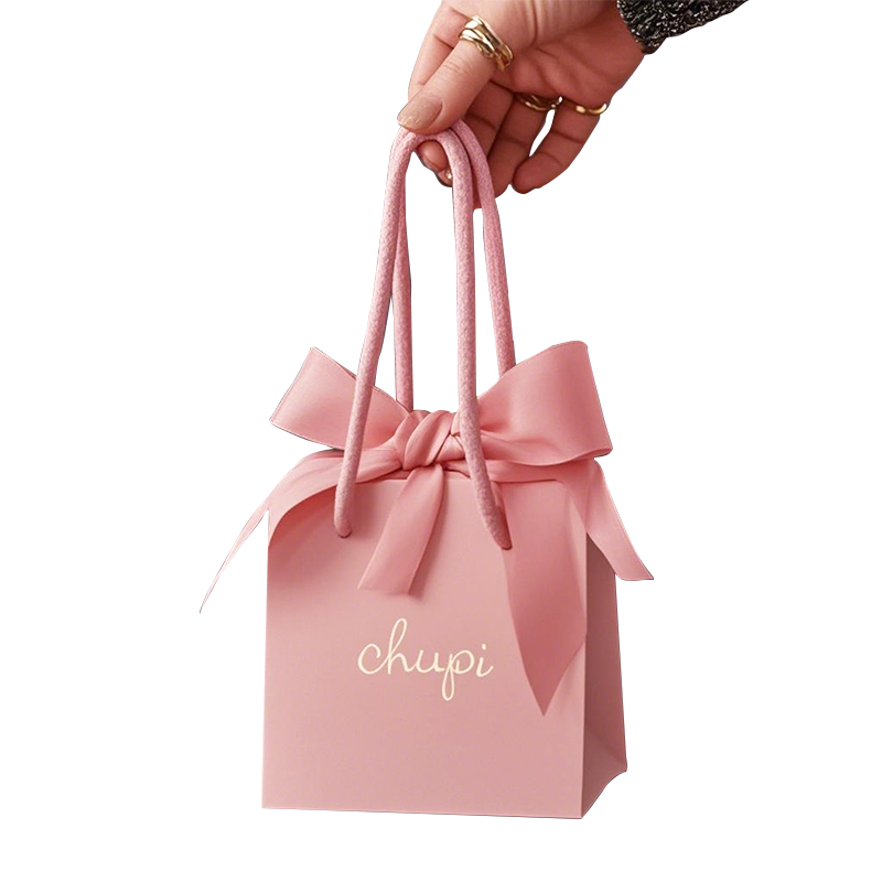 Carry gift paper bag with ribbon